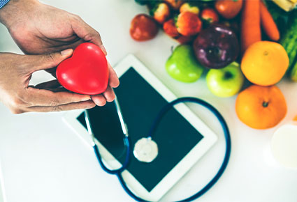 hands holding a plastic heart fruit vegetables