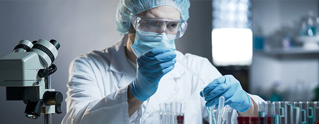 Male oncology lab technician testing tissue samples for cancer