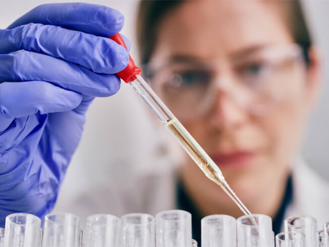 Shot of a young woman conducting an experiment in a lab