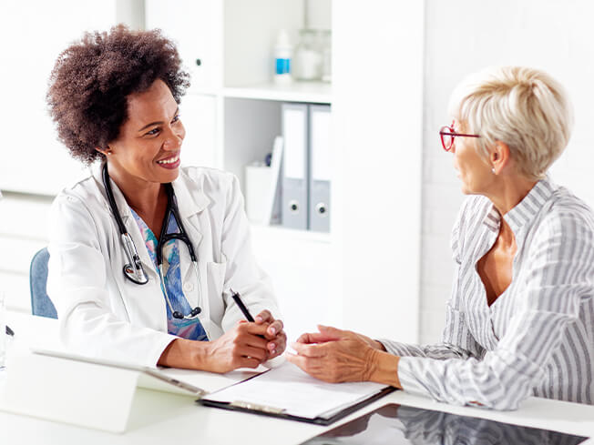 Female oncologist with female cancer patient