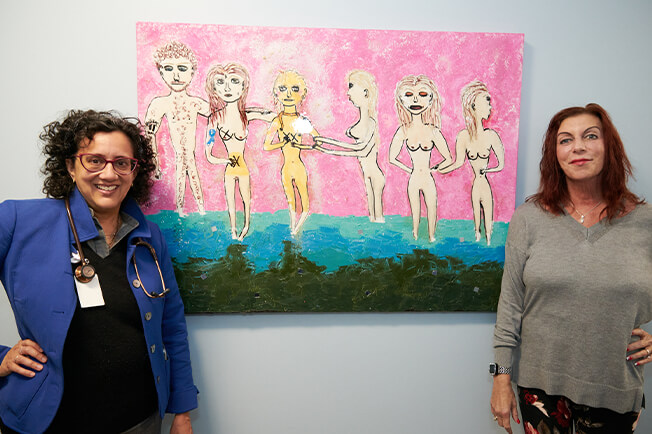 Alpana Desai MD and Robin Marshall with painting 121323