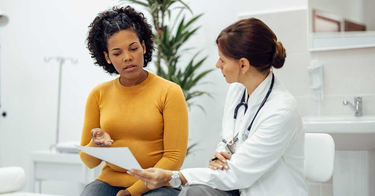 Woman speaking with doctor