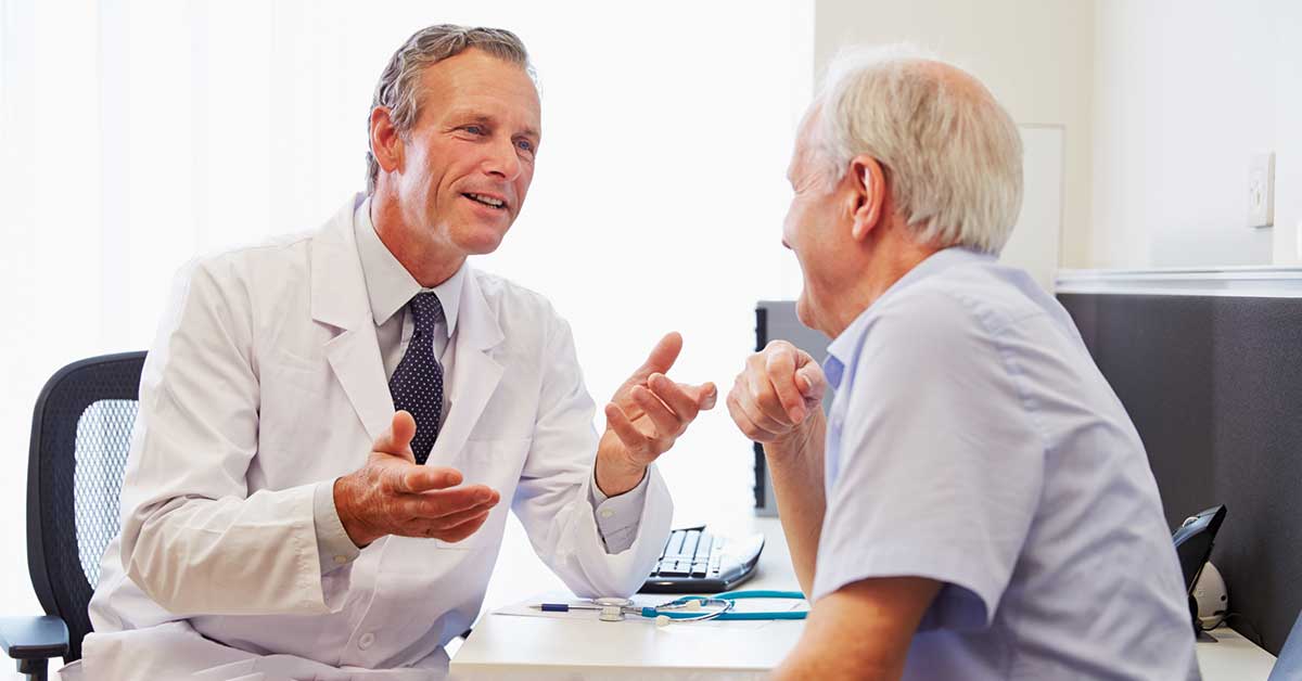 Senior Patient Having Consultation With Doctor In Offic