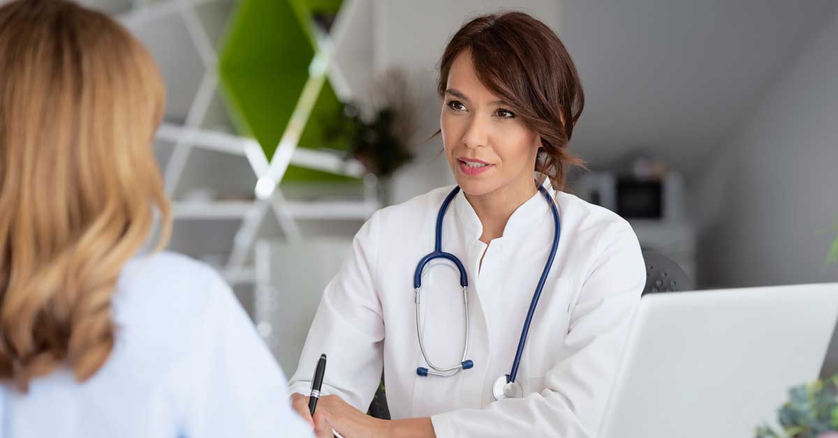 Female doctor consulting with her patient while sitting at the doctor's office