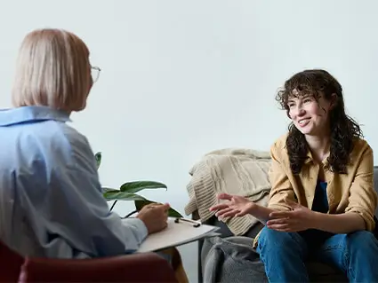 Woman sitting and speaking to a therapist