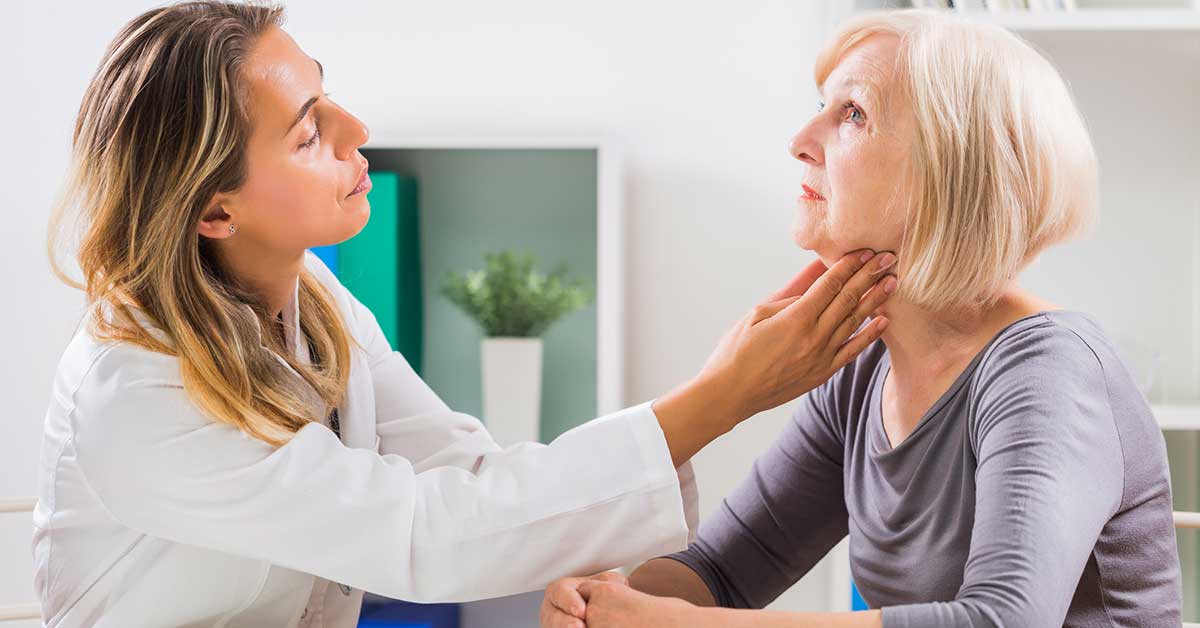 Doctor checking patients throat