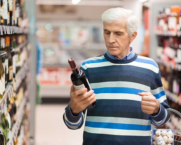 Man reading wine label