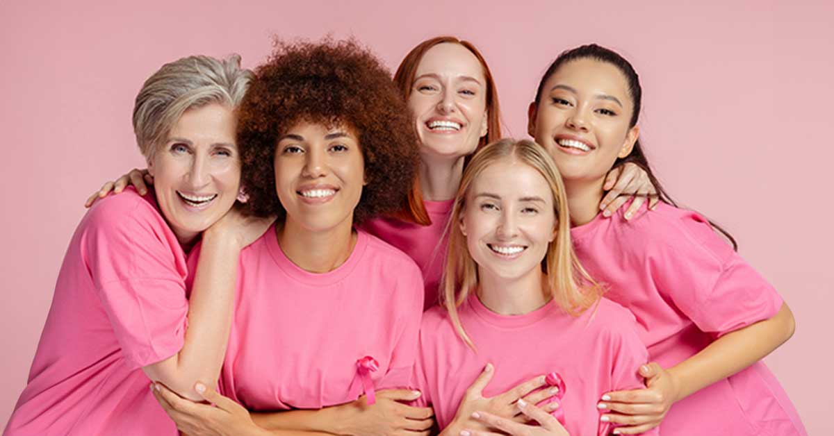 5 women wearing pink