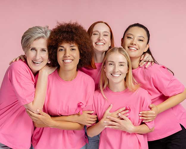 5 women wearing pink