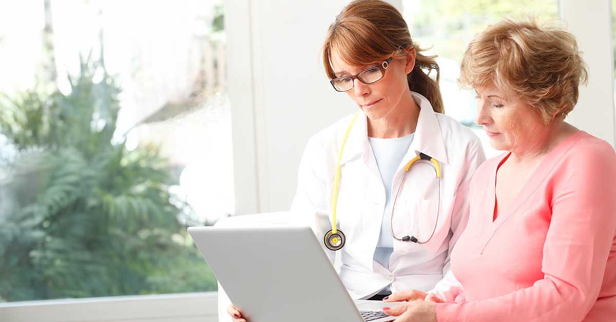 Patient and doctor looking at a computer